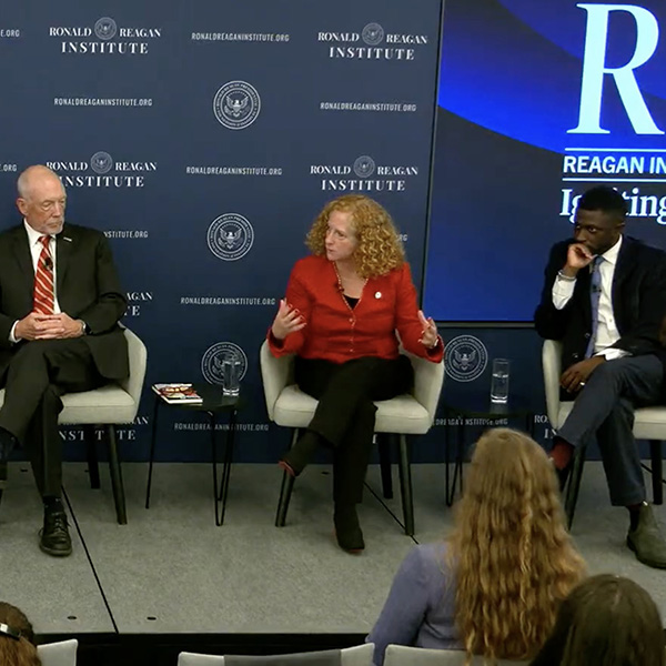 Chancellor Jennifer Mnookin on stage during a panel at the Reagan Institute Summit with for four other individuals.